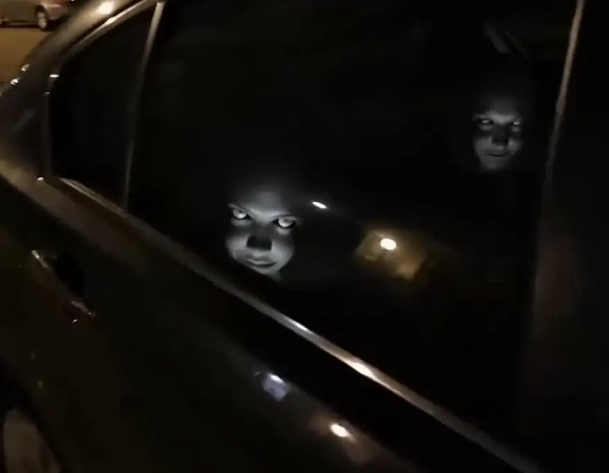 Haunted headrest covers glowing in a dark car